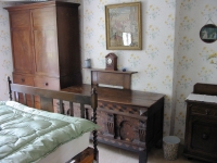 One of Myrtle House's double bedrooms, with interesting antique furniture